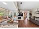 Warm and welcoming living room boasts wood flooring, fireplace, and French doors leading to the outdoors at 903 S Lakeview Ave, Bartow, FL 33830