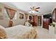Comfortable main bedroom featuring a ceiling fan and sliding barn door closet at 903 S Lakeview Ave, Bartow, FL 33830
