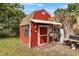 A small shed with new paint and trim sits on a well-maintained lawn at 903 S Lakeview Ave, Bartow, FL 33830