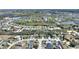 Aerial view of the home showcasing its location in a residential neighborhood with trees at 916 Balmoral Dr, Davenport, FL 33896