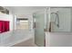 Bathroom featuring a tiled tub and shower with a glass door at 916 Balmoral Dr, Davenport, FL 33896