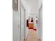 A hallway leading to a bathroom with tile flooring and a wooden vanity at 916 Balmoral Dr, Davenport, FL 33896