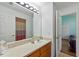 Bright bathroom with a vanity and an open doorway revealing another bedroom space at 916 Balmoral Dr, Davenport, FL 33896