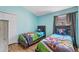 Charming ' bedroom with twin beds and cartoon-themed bedding in a blue painted room at 916 Balmoral Dr, Davenport, FL 33896