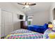 Shared bedroom with two beds, ceiling fan, and dark wood furnishings at 916 Balmoral Dr, Davenport, FL 33896