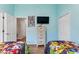 Charming ' bedroom with twin beds and cartoon-themed bedding in a blue painted room at 916 Balmoral Dr, Davenport, FL 33896