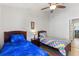 Bedroom with two beds, ceiling fan, and wood-look floors for a cozy and inviting space at 916 Balmoral Dr, Davenport, FL 33896