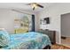 Inviting bedroom featuring a window view, ceiling fan and mounted TV at 916 Balmoral Dr, Davenport, FL 33896