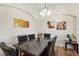 Elegant dining room with a marble-top table, leather chairs, and contemporary artwork adorning the walls at 916 Balmoral Dr, Davenport, FL 33896