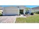 Charming one-story home featuring a well-manicured lawn and a neatly paved driveway at 916 Balmoral Dr, Davenport, FL 33896