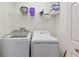 Practical laundry room includes a washer, dryer, and shelving for storage and organization at 916 Balmoral Dr, Davenport, FL 33896