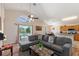 Comfortable living room featuring a gray sectional couch and views of the pool at 916 Balmoral Dr, Davenport, FL 33896