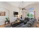 Relaxing living room with a comfortable sectional sofa, vaulted ceilings, and views of the outdoor pool area at 916 Balmoral Dr, Davenport, FL 33896