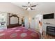 Main bedroom with a ceiling fan, a large bed, and doorways to other rooms at 916 Balmoral Dr, Davenport, FL 33896