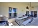 Covered patio featuring a ceiling fan, dining table with benches, and sliding glass doors to the interior at 916 Balmoral Dr, Davenport, FL 33896
