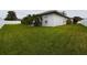 Lush backyard with green grass, privacy fence, and mature landscaping offering a serene and private outdoor space at 7726 Ashford Dr, Lakeland, FL 33810