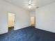 Spacious bedroom boasts plush blue carpeting and an adjacent walk-in closet, blending style and functionality at 7726 Ashford Dr, Lakeland, FL 33810