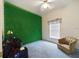 Bedroom with a wall covered in green decorations, ceiling fan, window and seating at 7726 Ashford Dr, Lakeland, FL 33810
