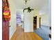 Inviting foyer featuring wood floors, a colorful wreath on the front door, and an open view to the kitchen at 7726 Ashford Dr, Lakeland, FL 33810