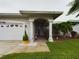 Inviting home entrance with a decorative front door, manicured landscaping, and a bright, welcoming atmosphere at 7726 Ashford Dr, Lakeland, FL 33810