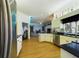 Kitchen featuring wood floors, stainless steel appliances and black countertops at 7726 Ashford Dr, Lakeland, FL 33810