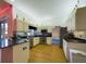 Well-lit kitchen featuring wood floors, modern appliances and black countertops at 7726 Ashford Dr, Lakeland, FL 33810