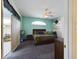 Cozy primary bedroom featuring plush carpeting, neutral walls, a ceiling fan, and access to a private outdoor space at 7726 Ashford Dr, Lakeland, FL 33810