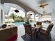Screened-in pool with outdoor seating, ceiling fans, and charming hanging floral arrangements at 7726 Ashford Dr, Lakeland, FL 33810