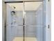 Tiled shower with glass doors and chrome fixtures offers a clean and modern look at 7726 Ashford Dr, Lakeland, FL 33810