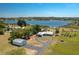 Aerial view of property showcasing a waterfront home, detached garage, and lake access at 100 Masterpiece Rd, Lake Wales, FL 33898