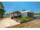Landscaped backyard with raised garden beds, a gazebo, a storage shed, and partial lake views at 100 Masterpiece Rd, Lake Wales, FL 33898