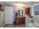 Bathroom featuring a vanity with sink, storage cabinet, and tiled shower at 100 Masterpiece Rd, Lake Wales, FL 33898