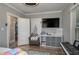 Spacious bedroom with a comfortable armchair, television, and storage unit at 100 Masterpiece Rd, Lake Wales, FL 33898