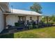 Charming home featuring a covered front porch with rocking chairs and a well-maintained yard at 100 Masterpiece Rd, Lake Wales, FL 33898