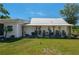 Charming home featuring a welcoming front porch with classic rocking chairs and a metal roof at 100 Masterpiece Rd, Lake Wales, FL 33898