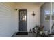 Cozy front porch with seating and a decorative compass and wreath on the door at 100 Masterpiece Rd, Lake Wales, FL 33898