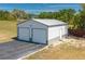 Two-car garage with a gray metal roof and siding, perfect for storage or hobbies at 100 Masterpiece Rd, Lake Wales, FL 33898