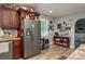 Spacious kitchen featuring stainless steel appliances, dark wood cabinets and a decorated coffee bar at 100 Masterpiece Rd, Lake Wales, FL 33898