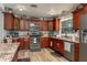 Kitchen showcasing stainless steel appliances, granite countertops, and dark wood cabinets at 100 Masterpiece Rd, Lake Wales, FL 33898