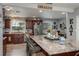 Bright and open kitchen featuring an island with seating, stainless steel appliances and wood cabinetry at 100 Masterpiece Rd, Lake Wales, FL 33898