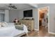 Main bedroom featuring wood floors, a ceiling fan, and an entrance to the ensuite bathroom at 100 Masterpiece Rd, Lake Wales, FL 33898