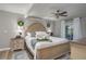 Spacious main bedroom with a king bed, ceiling fan, soft lighting, and decorative wreaths at 100 Masterpiece Rd, Lake Wales, FL 33898