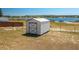 Exterior view of shed with lake in the background, provides ample storage space at 100 Masterpiece Rd, Lake Wales, FL 33898