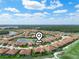 Aerial view of a residential community with beautiful landscaping and a central pond feature at 1057 Sawgrass Dr, Winter Haven, FL 33884