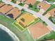 Aerial view of a home with a solar-paneled roof and screened lanai overlooking a scenic backyard at 1057 Sawgrass Dr, Winter Haven, FL 33884