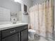 Charming bathroom with a vanity, shell-themed shower curtain, and framed art brings a seaside atmosphere at 1057 Sawgrass Dr, Winter Haven, FL 33884
