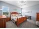 Bright bedroom features a traditional-style wooden bed frame and neutral patterned rug at 1057 Sawgrass Dr, Winter Haven, FL 33884