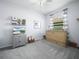 A bedroom featuring a unique Murphy bed, a dresser with a TV, and cozy decor offers an inviting space at 1057 Sawgrass Dr, Winter Haven, FL 33884