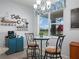 Cozy breakfast nook with seating for two and a bright window provides a relaxing view at 1057 Sawgrass Dr, Winter Haven, FL 33884