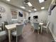 Bright and airy dining room with multiple tables, chairs, and stylish decor at 1057 Sawgrass Dr, Winter Haven, FL 33884